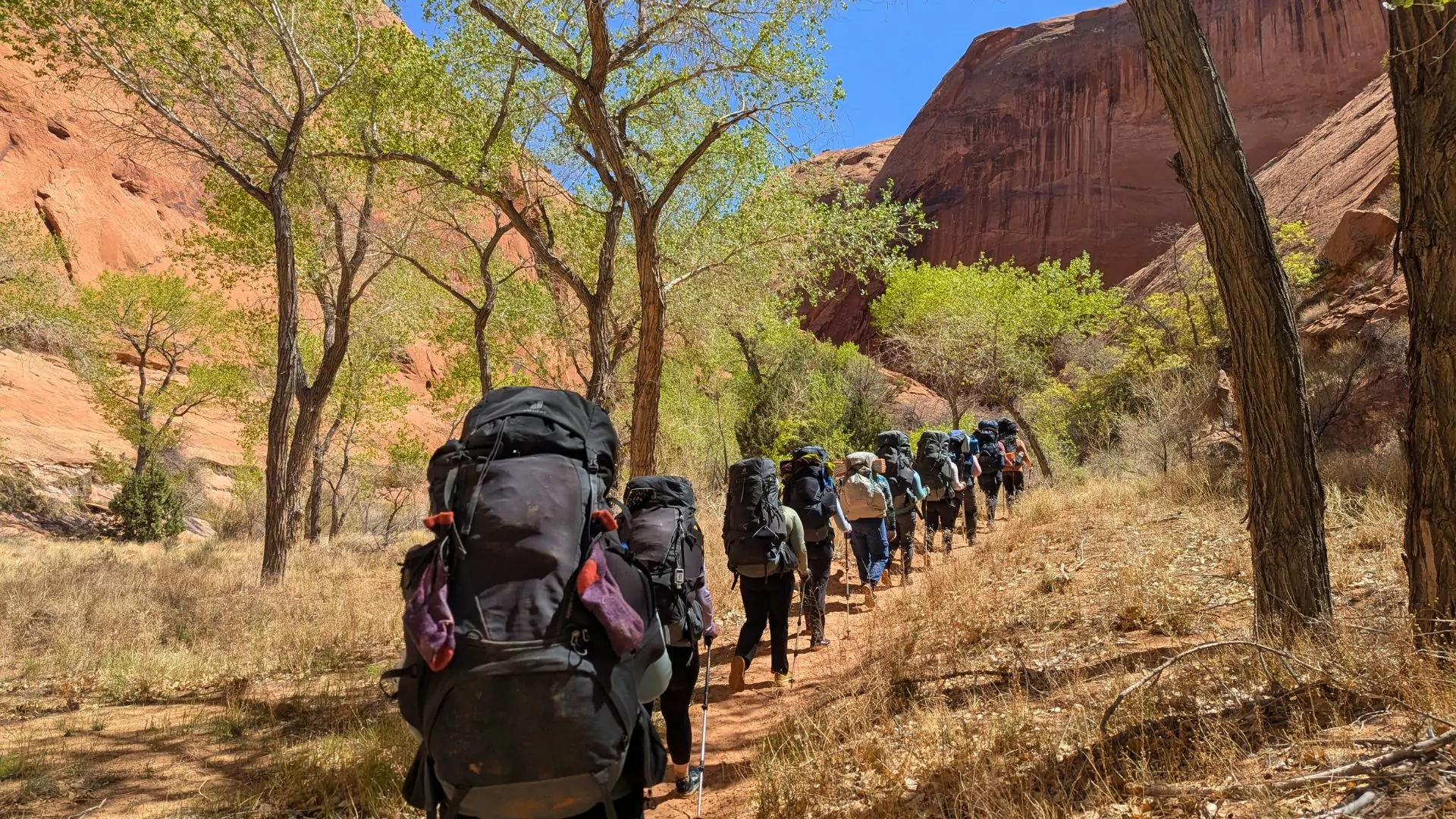 Women backpack in Coyote Gulch near Escalante