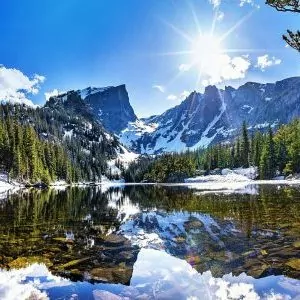 Crystal clear alpine lakes lined by recent snowfall in Rocky Mountain National Park