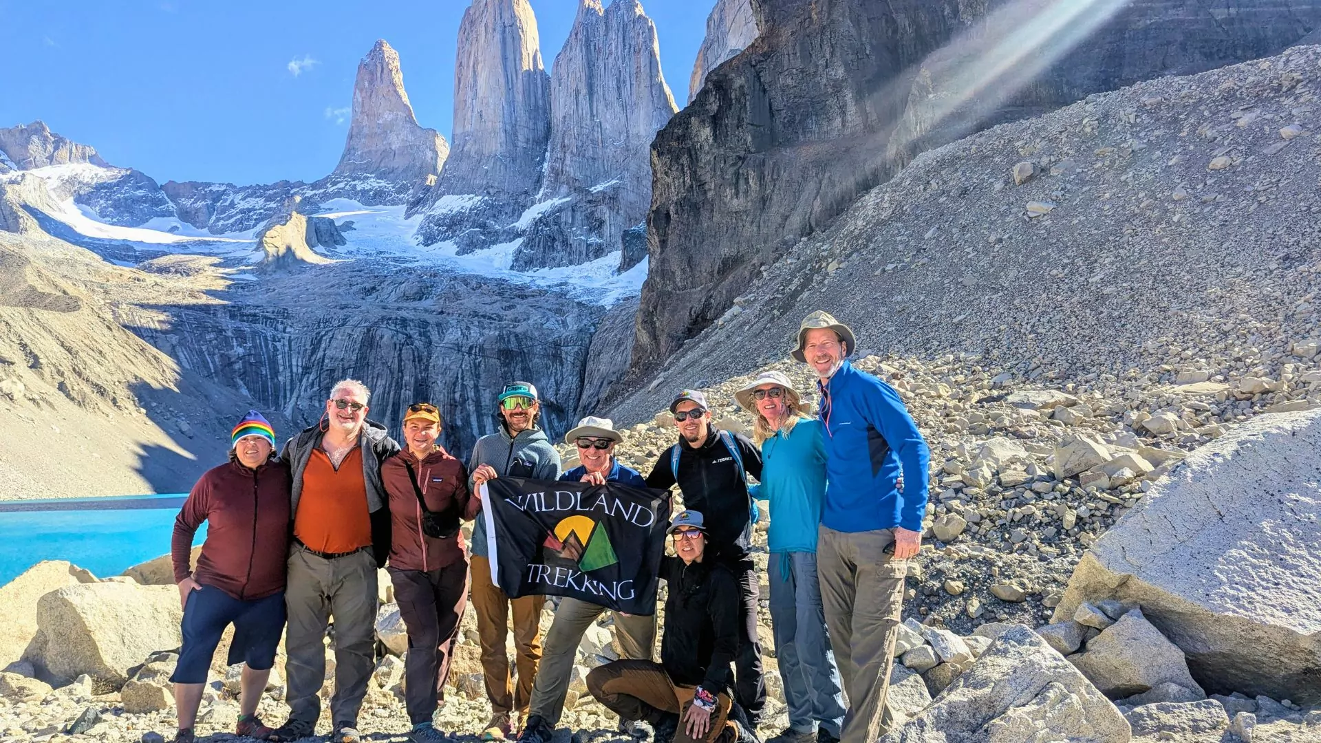 A group of hikers pose in front of the towers in Torres del Paine National Park