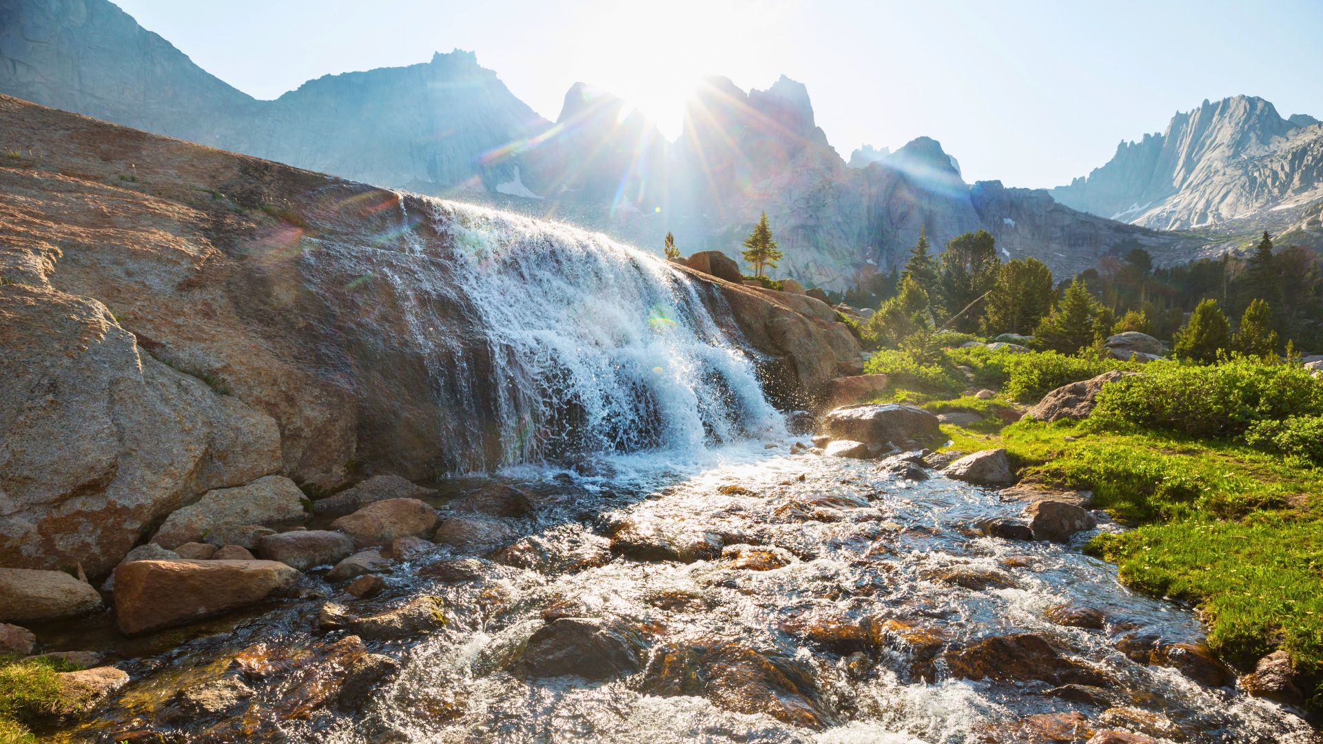 A waterfall pours from a creek in the wind river mountains